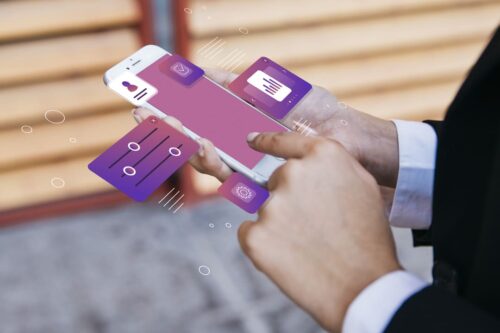 bancos digitais: uma pessoa mexendo no celular. A tela está em tom de roxo.
