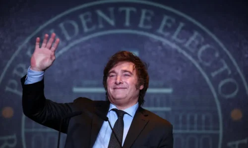 Javier Milei, presidente eleito da Argentina, acenando com a mão esquerda.