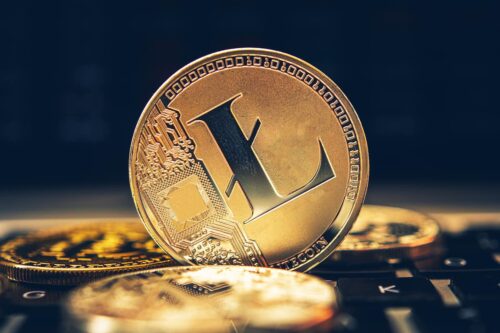 Moeda digital Litecoin sobre teclado, representando o conceito de investimentos em ETFs de criptomoedas no mercado financeiro.