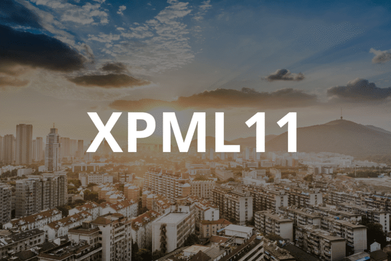 Vista panorâmica da cidade ao pôr do sol com céu parcialmente nublado, mostrando prédios residenciais e comerciais sob uma atmosfera de fim de tarde.