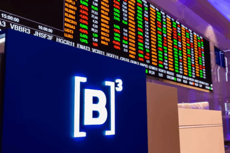 Imagem de uma tela de cotações de ações na bolsa de valores, com números em cores diferentes como verde, vermelho e amarelo, e o logo da B3 destacando-se na imagem.