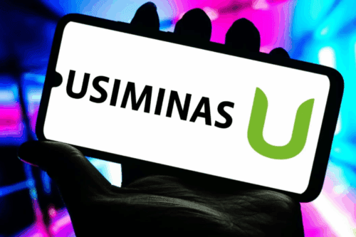 Imagem de um celular com a palavra 'Usiminas' e o logotipo da usina, destacando a presença da Usiminas no setor siderúrgico brasileiro.