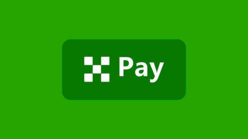 Logotipo verde da OKX Pay, plataforma de pagamentos em cripto com rendimento em dólar.