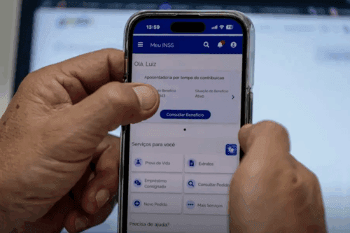 Pessoa utilizando o aplicativo Meu INSS em um smartphone para consultar informações sobre aposentadoria.