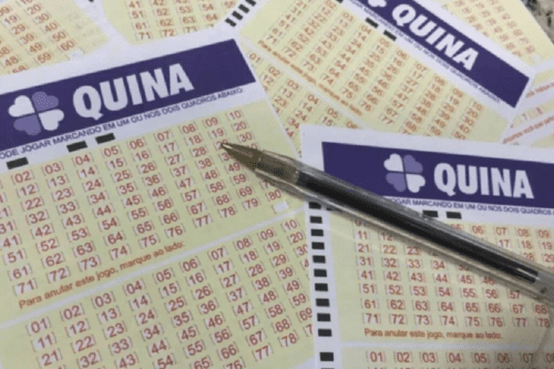 Imagem de diversos tickets de quina com uma caneta sobre eles, representando apostas na loteria Quina.